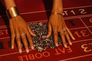 Hands placing chips on a roulette table as part of a roulette strategy